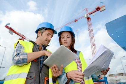 Construction manager and engineer working on building site